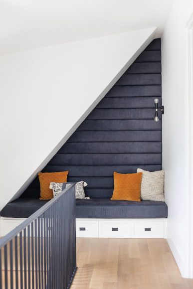 Tranquil nooks populate this house, like this tucked-in seating by the stairs. “This was a unique space as it was much deeper than most landings,” Simpson says. Anne is partial to the on-trend channeled upholstery.