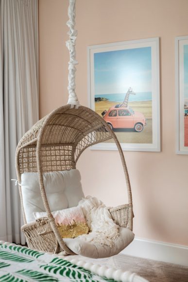 DREAMY SPOT
This pink bedroom belongs to the couple’s five-year-old daughter, Charlotte. The hanging chair has become a beloved place to daydream, while the spacious room allows for a queen-sized bed and desk — things that are in each child’s room. The closet with built-in drawers removes the need for a dresser, which gave Charlotte enough space to include a fun playtime feature — a make-believe vet office.