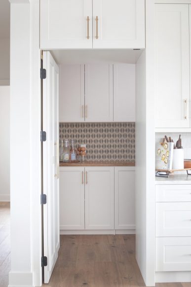 Smart Storage

All of the cabinets, including the ones in the pantry, were selected through Dream Kitchens. “Lindsay and I worked hard to get the wall layout to be symmetrical with the added hidden pantry door and the introduction of the beams through the cabinetry,” Van Wie recalls.