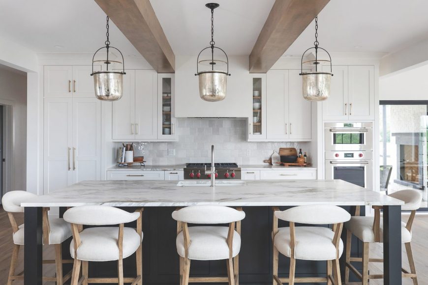 Stunning Space

The oversized silver- toned pendant lamps are striking accents in the white kitchen. Sourced from Madison Lighting, these Lorford Smoke Bell Lanterns were designed by Chapman and Myers of Visual Comfort.