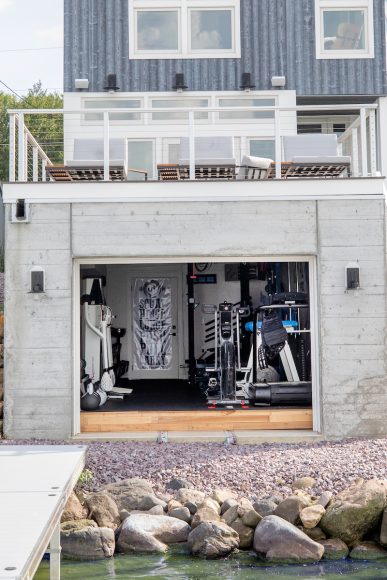 To transform the boathouse into a home gym, the couple had to build up the floor to make it level and sturdy enough to handle heavy equipment, such as a treadmill and full rack of dumbbells.