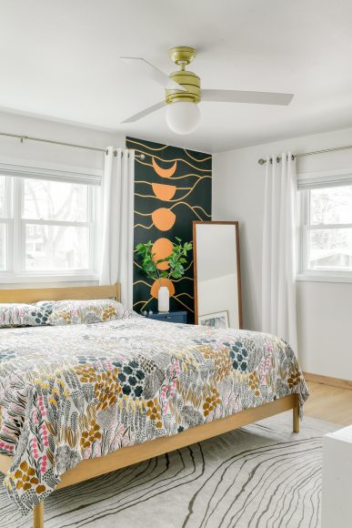 Scandinavian minimalism pairs with bold pops of color in the primary bedroom. “Once I embraced the idea of making the space supportive of my life and who I am, I was able to venture into more experimental color palettes,” Drammeh says.