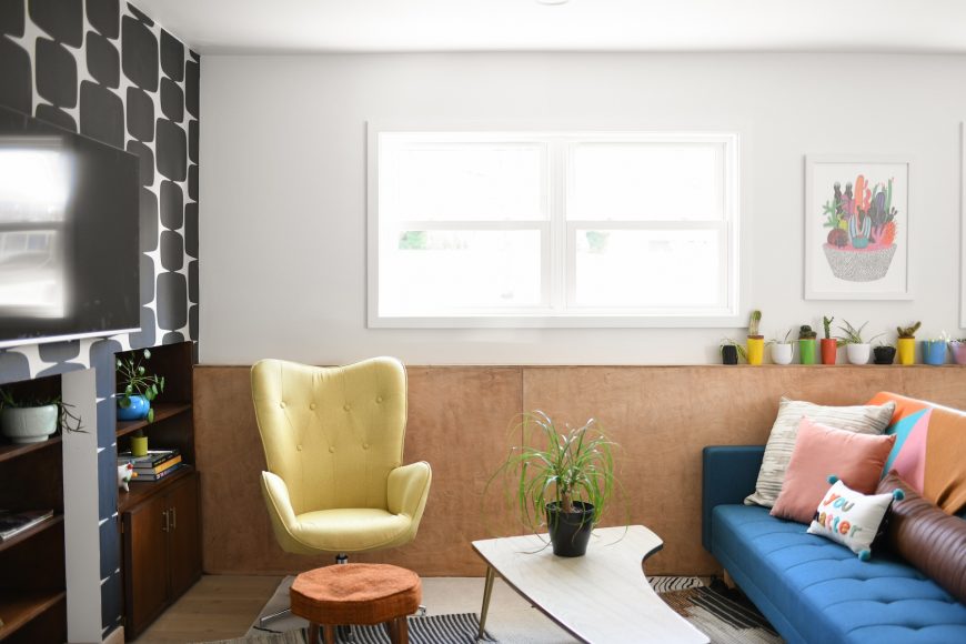 In the lower level, Drammeh installed custom-stained wood paneling to complement the kitchen cabinets, as well as an old built-in record player left behind. The plants here and throughout the home help connect her to nature.