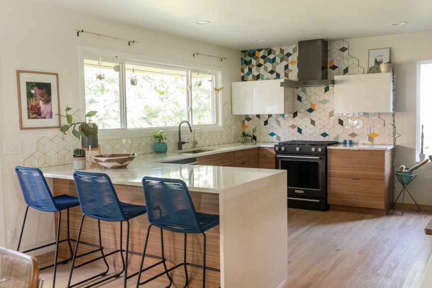 Handcrafted rhombus tiles by Minneapolis’ Mercury Mosaics cascade down the kitchen walls. “I don’t like edges, and I love organic movement,” says Drammeh, “so I wanted the tiles to trail off out of themselves.”