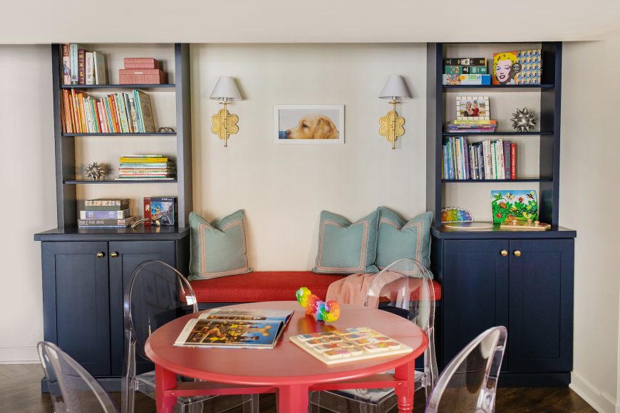 The grandchildren’s playroom is fun and quirky, with acrylic “ghost” chairs surrounding a vintage table painted an eye-catching coral, a color carried through in the custom bench cushion.