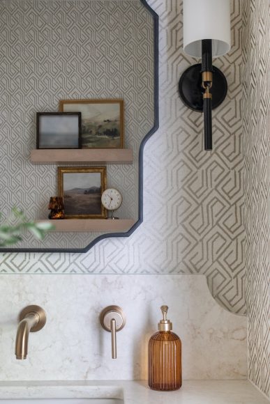 The powder room features a custom quartz wall-to-wall vanity top, designed by Figaro with the Granite Shop of Madison.