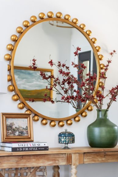 She sourced the entryway’s striking, 44-inch round gold leaf mirror from Fig Interiors.