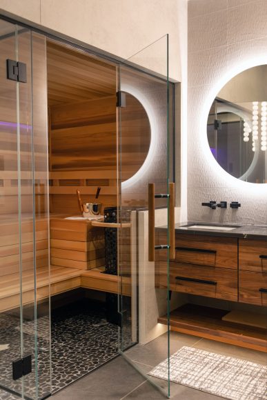 This cedar sauna is part of Cox’s spa. The pampering space is also home to a steam shower, curbless shower with numerous spray features and a mini fridge. The fridge is typically filled with bottles of water, the perfect refreshment after emerging from the sauna or steam shower. Nearby, a stone tub is great for long soaks. The tub is filled via a spout in the ceiling for a fun touch.