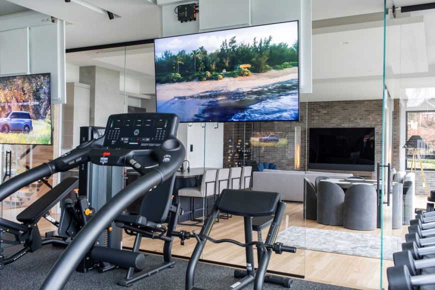 The home’s lower level has a fitness room that features two televisions tucked into the ceiling. When Cox is on her treadmill or exercise bike, she can lower one or both screens via remote.