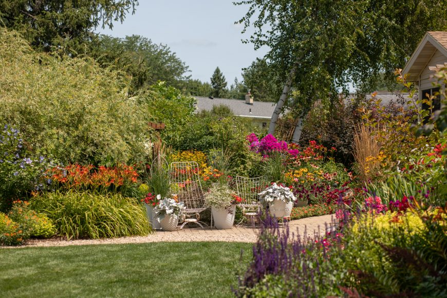 Garden paths throughout are comprised of grass, bricks, small rocks and stepping stones. The large, silver-leafed plants are called “Angel Wings” and Hemenway plants them annually.