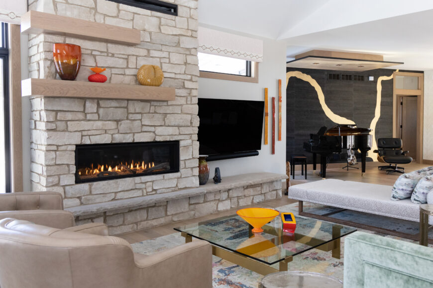 The stone fireplace, accented with alder beams, adds a classic touch to the home.