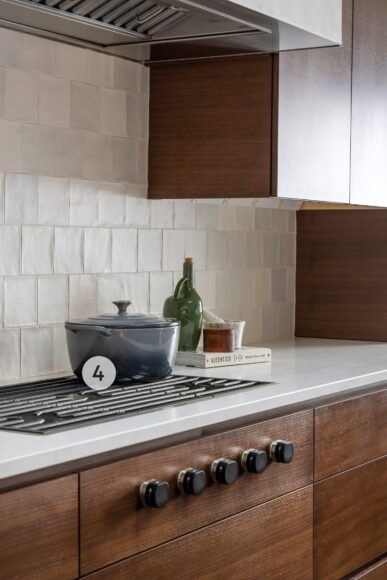 4. Look closely: The knobs for this Wolf 36” five-burner gas cooktop are integrated into the cabinetry below! Mestizaje’s white zellige matte tile adds polish to the space.
