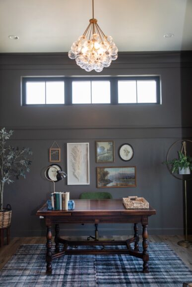 In the tucked-away office off of the stairway landing, Tonia used Sherwin-Williams’ Porpoise on the walls to create a cozy, moody vibe. A vintage table serves as a desk.