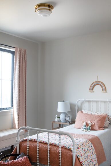 A sweet Wayfair iron bed frame with beaded accents is in one of the bedrooms.