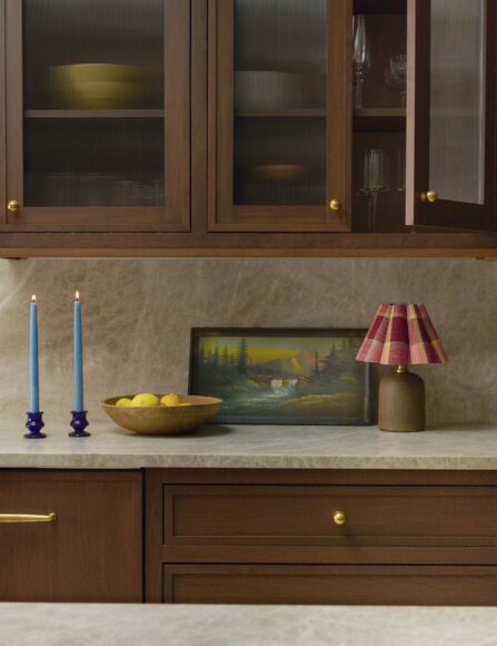 The frosted, fluted glass in the kitchen's upper cabinets adds lightness and interest to the room, while obscuring the items inside just enough to hide any messiness or mismatched pieces.