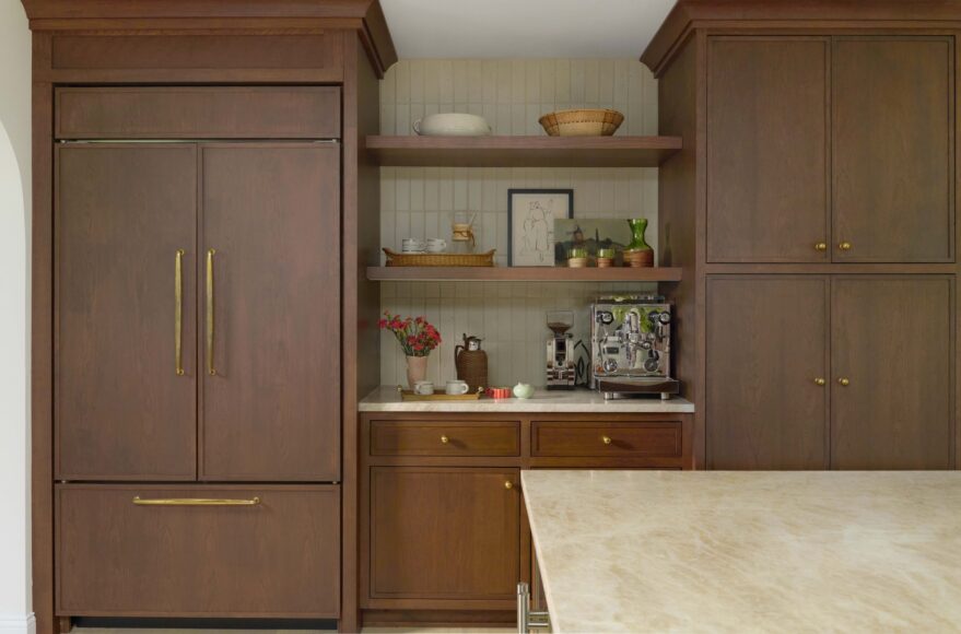 The breakfast bar, tucked next to the refrigerator, is the perfect spot for the couple’s espresso machine and coffee grinder. Clé Heritage tile in Carpenter’s Canvas forms the backdrop, complementing the Taj Mahal quartzite in the rest of the kitchen.