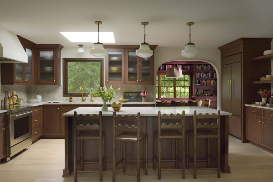 The airy kitchen features Amish-crafted cherry cabinetry and a 36-inch Wolf transitional induction range that the couple finds very easy to use and clean. But it’s the island that shines, with Dilworth pendant lights from Worley’s Lighting and curved-back reclaimed wood chairs from Etsy, finished in rustic brown.