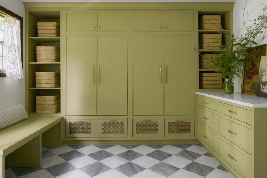 The home’s expansive mudroom makes it easy for the family to stay organized, with plenty of space for coats, mittens, boots and more. It also has a playful vibe, with the cabinetry and bench painted with Sherwin-Williams’ Bamboo Shoot, and marble and slate flooring set in a diamond pattern.
