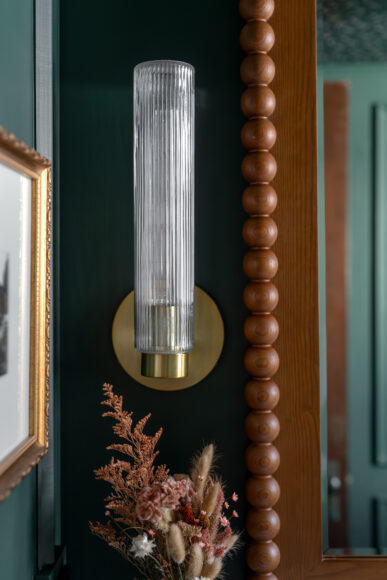 “What I love most about this room is how it feels at night,” says Hansen, adding that she employed dimmers. “The entire mood can shift depending on … the atmosphere I want to create.” The Weston Fluted Glass Wall Sconces are from West Elm.