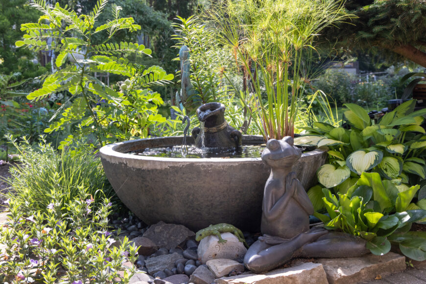 The garden’s water feature has a serene-looking toad enjoying its surroundings. Goldfish live in the bowl year-round, thanks to a small heater that keeps the water warm through the winter.