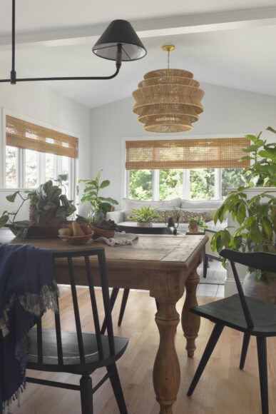 Shown from an alternate view, the home’s sunroom has a vintage-look table topped with houseplants — the perfect spot for doing a puzzle, enjoying a cup of tea or playing a board game with family.
