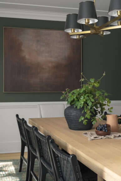 Lush greenery was a priority for the homeowners and houseplants can be found in virtually every room. “We usually lean on Stein’s Garden & Home in Milwaukee for plants,” says Franklin. The Ethnicraft dining room table pairs nicely with Stone House Collective chairs. The light fixture is from Currey & Company.
