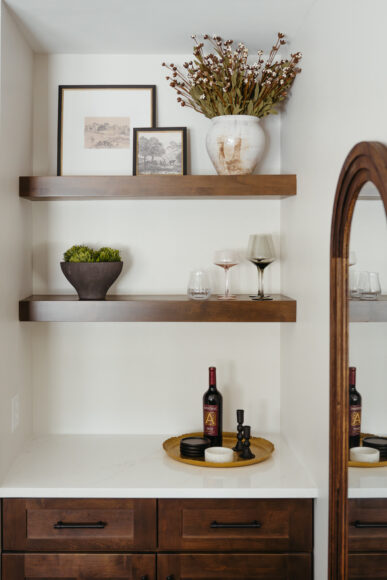 Schaaf says they were able to squeeze a bar nook into the living room to add a bit of storage and style. “That little nook was a special addition and … a surprise that came out of the floor plan. We ended up doing a built-in. Part of it is faux, because if you open the cabinets … it hides some mechanicals.”