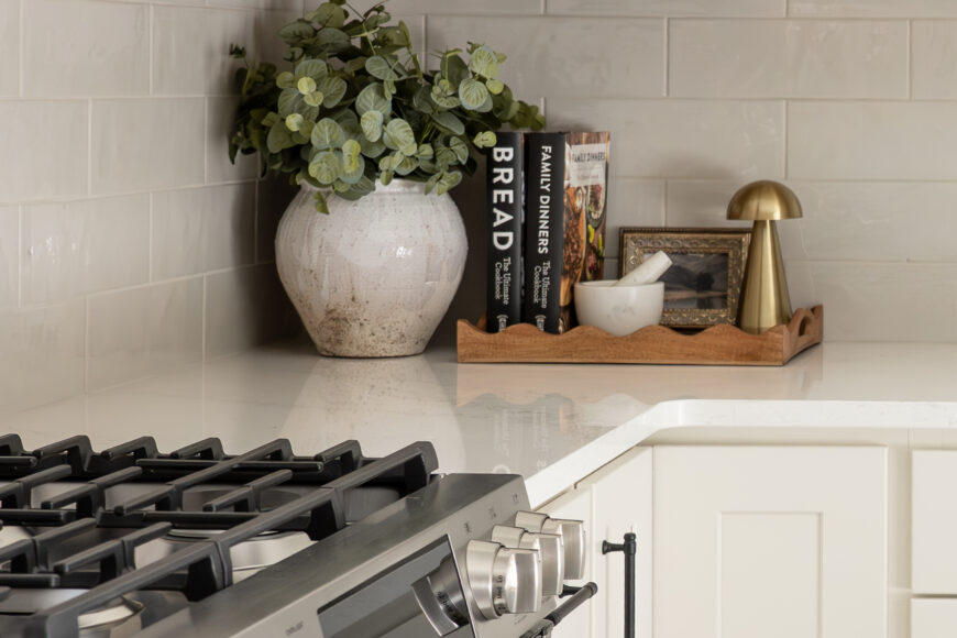 Schaaf says the kitchen “definitely [has] a subtle European influence with the creamy cabinetry, the warm tones, tiled floor and beautiful backsplash.” The Shaker-style kitchen cabinetry, range hood, backsplash and quartz countertops are all from CTW Design Center in McFarland.