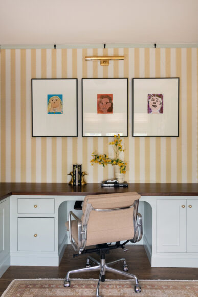 Above one desk, Payne says they mounted and framed self-portraits by each of the couple’s children. She says, “We were just racking our brains for what we could do with the art here, and then the homeowners pulled out the kids’ school art, and we found these.”
