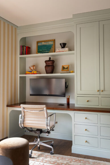 The home’s blue color palette extends into the office, where light blue cabinetry and arched, built-in shelving echoes the graceful arched doorways found throughout the home.